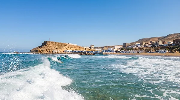 Surfers at Imsouane â€” longboard riding on the Atlantic coast of Morocco