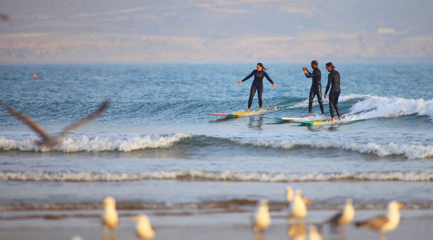 Imsouane surf camp Morocco â€” beginner-friendly waves at the Bay with longboard surfers on the Atlantic coast